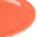 A close-up of a Carlisle Sunset Orange melamine plate.