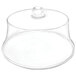 A clear acrylic dome cover over a plate with a clear glass cup inside.