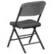 A gray padded folding chair with a grey seat and back.