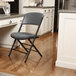 A gray Lifetime padded folding chair in a kitchen.