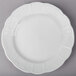A Tuxton Chicago bright white china plate with a decorative edge.