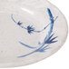 A close-up of a Thunder Group Blue Bamboo melamine plate with a blue and white design.