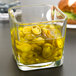 A Libbey cube glass jar filled with yellow peppers.