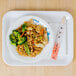 A Blue Bamboo melamine tray with a plate of rice, broccoli, and chicken on a white surface.