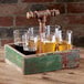A GET reclaimed wood condiment caddy holding six glasses of beer on a table.
