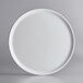 A GET Madison Avenue white melamine display plate with a round rim.