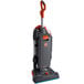 A grey and orange Hoover HushTone 15+ commercial bagged upright vacuum cleaner with a handle.