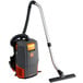 A Hoover commercial backpack vacuum cleaner with an orange and grey handle.