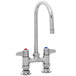 A chrome Equip by T&S deck-mounted faucet with two lever handles and a gooseneck spout.