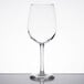 A clear Libbey Vina wine glass on a table with a reflection.