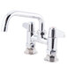 A chrome Equip by T&S deck-mounted faucet with lever handles and a 6 1/8" swing spout.