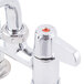 A chrome Equip by T&S deck-mounted faucet with lever handles.
