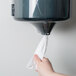 A person using Merfin 2-ply center pull paper towels in a paper towel dispenser.