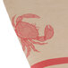 A brown paper table cover with a white drawing of a crab.