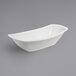 A white oval GET Enterprises melamine serving bowl on a gray surface.