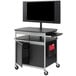 A black Safco Scoot flat panel multimedia cart with a monitor on it.