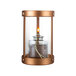 A Sterno copper and glass votive candle holder with a lit candle inside.