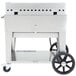 A large stainless steel Crown Verity outdoor griddle on wheels with a black handle.