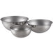 A set of three stainless steel Vollrath mixing bowls.