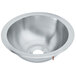A silver stainless steel Vollrath sink bowl with a round compartment and a hole in it.