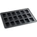 A black steel Wilton mini loaf pan with 18 compartments.
