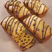 A group of mini loaves of chocolate chip pumpkin bread with chocolate drizzle on top in a Wilton 4-compartment mini loaf pan.
