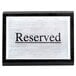 An American Metalcraft black wood "Reserved" sign on a table.