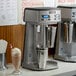 A Waring double spindle milkshake machine on a counter.
