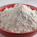 A bowl of Bob's Red Mill gluten-free oat flour on a white table.