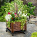 A DeVault planter dolly with flowers and plants in it.