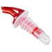 A Tablecraft red and clear plastic liquor pourer with a clear tail.