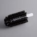A black and white circular Noble Products glass washer brush.