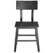 A black Lancaster Table & Seating dining side chair with a wooden seat and backrest.