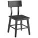 A black Lancaster Table & Seating dining side chair with a wooden seat and back.