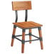 A Lancaster Table & Seating Rustic Industrial dining side chair with a black metal frame.