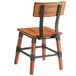 A Lancaster Table & Seating rustic industrial dining side chair with a wooden seat and black metal frame.