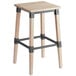 A Lancaster Table & Seating rustic wooden backless bar stool with legs and a white seat.