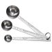 A set of Vollrath stainless steel round measuring spoons with a metal handle.