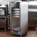 A Metro C5 non-insulated heated holding and proofing cabinet with trays inside.