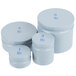 A close-up of three white plastic containers with blue numbers on them.