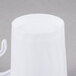 A close up of a Fineline white plastic coffee mug with a handle.