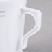 A close-up of a Fineline white plastic coffee mug with a handle.