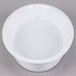 A white oval casserole dish with a round center.