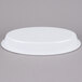A white oval melamine casserole dish with a white plastic lid.