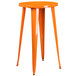 An orange metal table with legs.