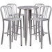 A Flash Furniture silver metal bar height table with four chairs with a white surface.