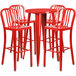 A Flash Furniture red metal bar table and four red stools.