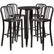 A Flash Furniture black metal bar height table with four chairs with black metal vertical slat backs.