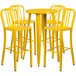 A Flash Furniture yellow metal bar table with four yellow stools.