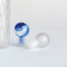 A close-up of a blue and white swirly glass stopper.